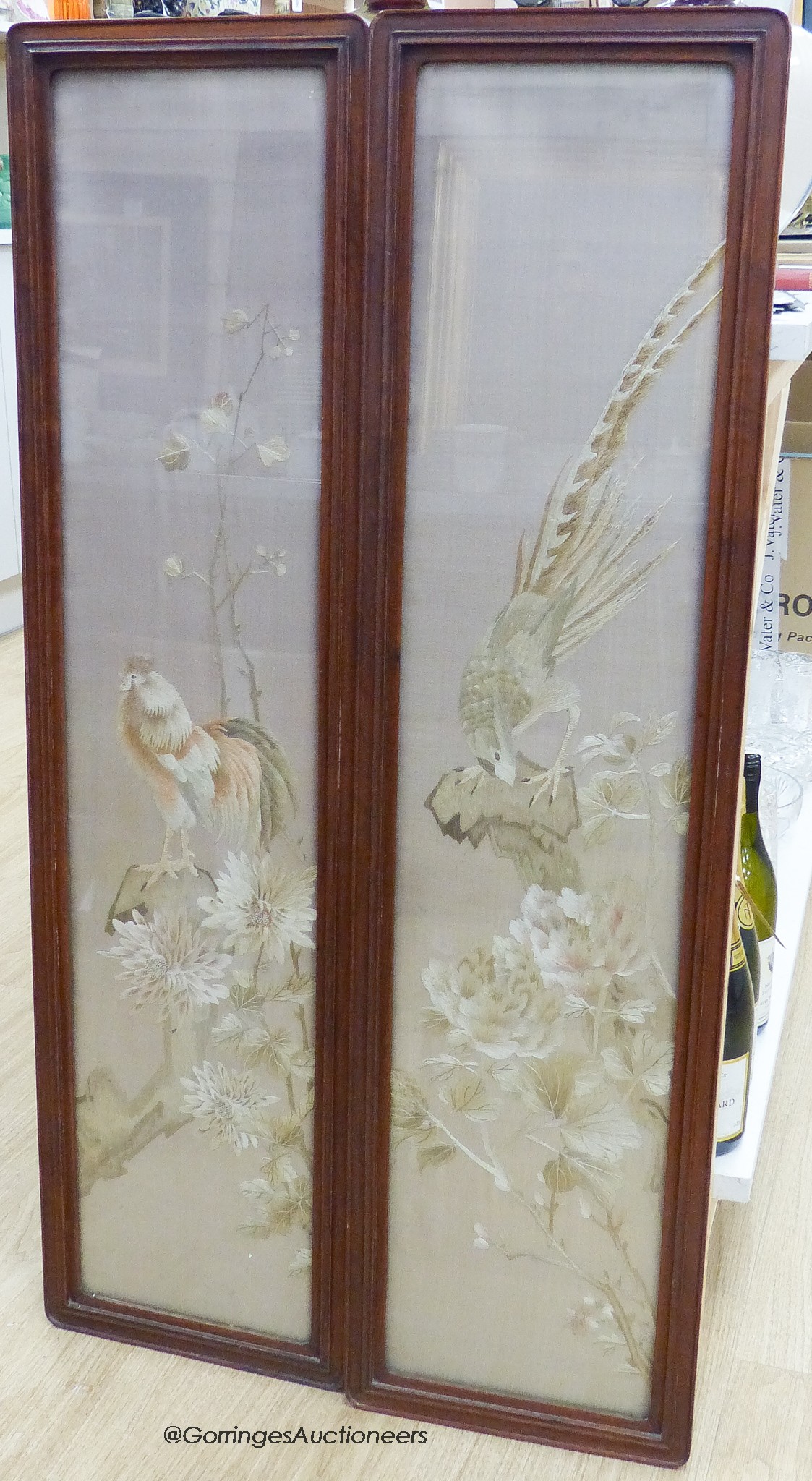 A pair of late 19th century Chinese embroidered silk pictures, in hongmu frames, 111 cm x 29 cm in total